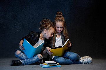 Image showing Two kids reading the books at studio