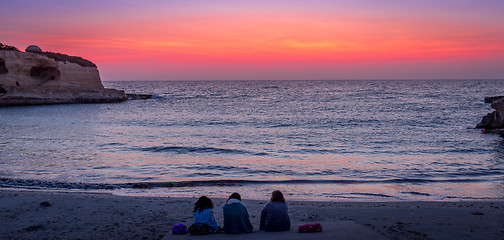 Image showing Three friends looking to the sunrise