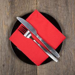 Image showing Plate, knfie and fork on a napkin.