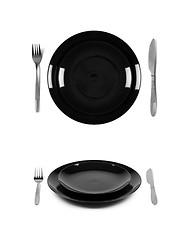 Image showing Two black plates with fork and knife