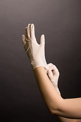 Image showing Putting on latex gloves