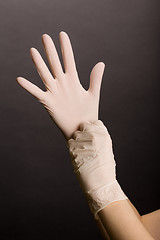 Image showing Putting on latex gloves