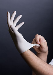 Image showing Putting on latex gloves