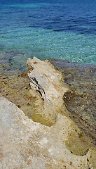 Image showing Bright turquoise sea water and coastal rocks