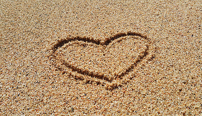 Image showing Drawing of abstract heart in the sand background