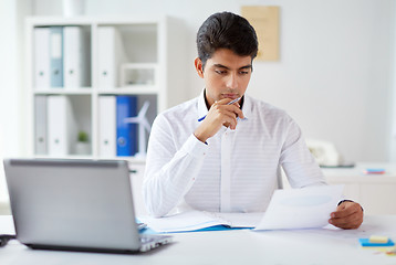 Image showing businessman working with papers at office