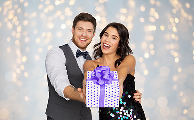 Image showing happy couple with gift box at birthday party