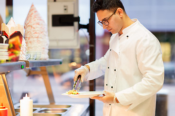 Image showing chef with salad on plate at fast food restaurant