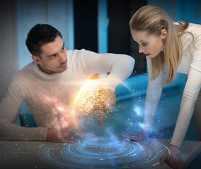 Image showing couple using touch screen over space background