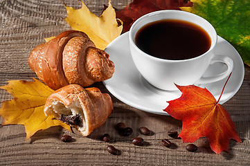 Image showing Cup of black coffee with croissants