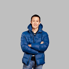 Image showing Asian man in blue down-padded coat