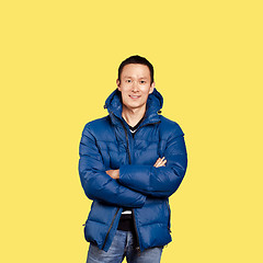 Image showing Asian man in blue down-padded coat