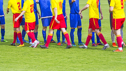 Image showing Two soccer team handshake on field before the football game