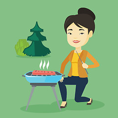 Image showing Woman cooking steak on barbecue grill.