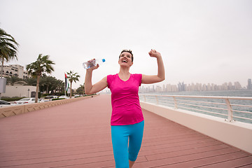 Image showing young woman celebrating a successful training run