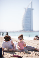 Image showing Mom and daughter on the beach