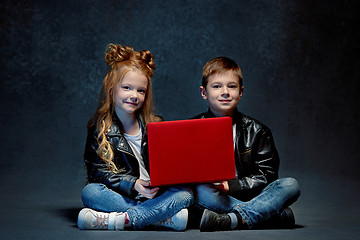 Image showing Studio shot of two children with laptop