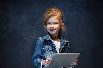 Image showing Little girl sitting with tablet