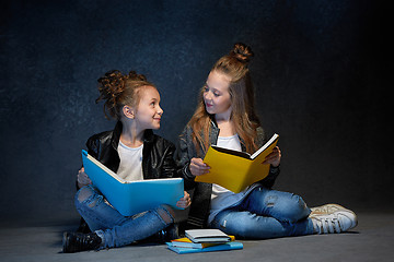 Image showing Two kids reading the books at studio