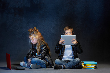Image showing Studio shot of two children with laptop