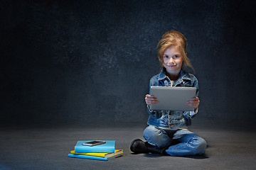 Image showing Little girl sitting with tablet
