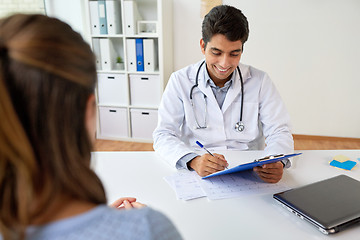 Image showing doctor with clipboard and patient at hospital