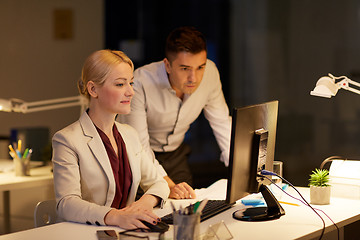 Image showing business team with computer working late at office