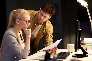 Image showing business team with papers working late at office