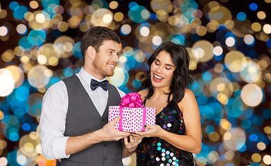 Image showing happy couple with gift box at birthday party