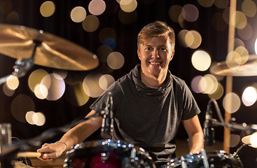 Image showing male musician playing drum kit at concert