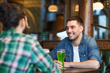 Image showing male friends drinking green beer at bar or pub