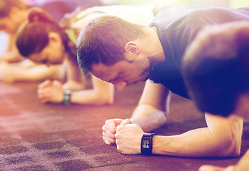 Image showing man with heart-rate tracker exercising in gym