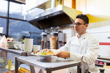 Image showing chef with dish on plate at kebab shop