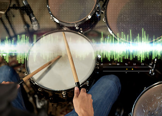 Image showing male musician playing drum kit at concert