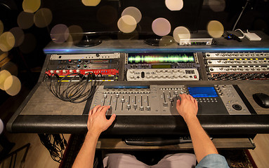 Image showing man using mixing console in music recording studio