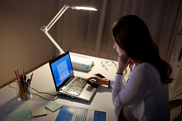 Image showing businesswoman with laptop at night office