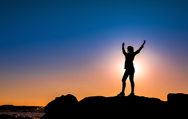 Image showing Woman on top a of the rock