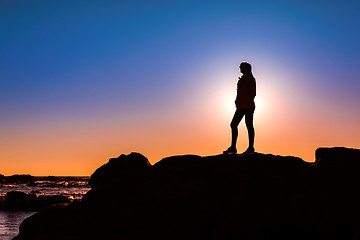 Image showing Woman on top a of the rock