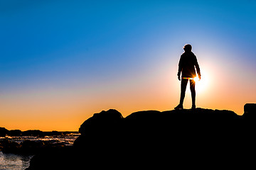 Image showing Woman on top a of the rock