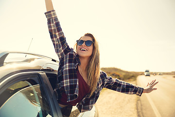 Image showing happy girl looking out the car window