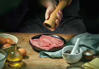 Image showing cook is seasoning meat