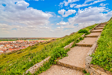 Image showing Staircase to the sky. Huge stairway leading up a green hill