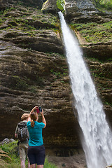 Image showing Active tourists looking at Pericnik waterfall in Vrata Valley in Triglav National Park in Julian Alps, Slovenia.