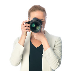 Image showing Beautiful young photographer with camera in professional studio