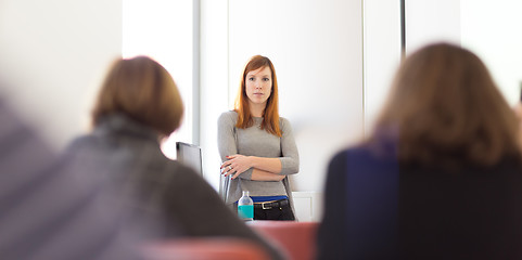 Image showing Woman giving presentation in lecture hall at university.