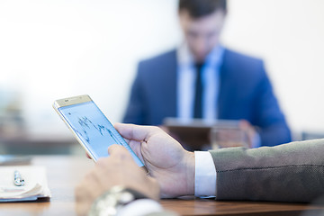 Image showing Close up of businessman using mobile smart phone.