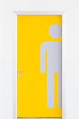 Image showing Men symbols on yellow public toilet entrance door.