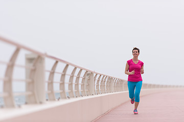 Image showing woman busy running on the promenade