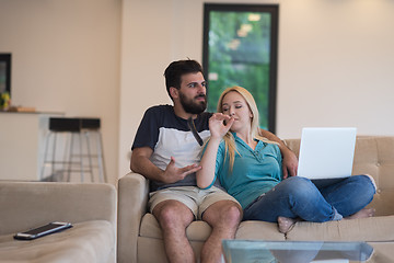 Image showing young happy couple relaxes in the living room