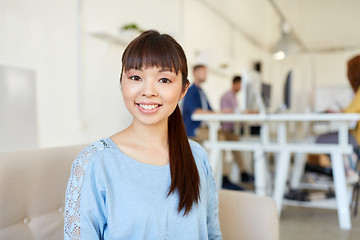 Image showing happy creative female worker at office